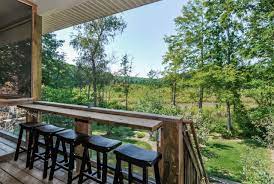 Here, metal slats are run between top and bottom wood railings, with wide wood posts every few feet. Deck Rail Bar Houzz