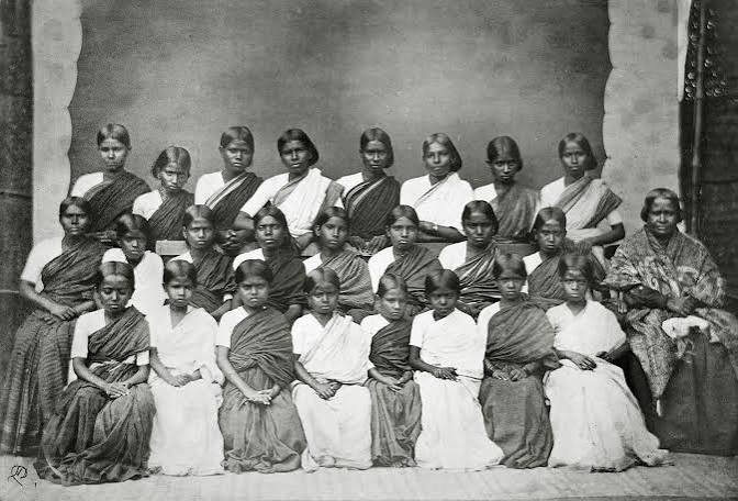 An old photographic image of an English 'memsahib' with some Indian ladies, British India, circa late 19th century. Can anyone please identify the location more precisely? Somebody told me it could be