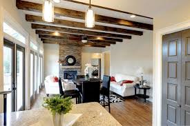 Light wood ceiling beams contrast with the room's dark gray walls and rich blue floor. Open Ceiling Beams And False Beams In The Interior Of The House 38 Photos