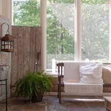 A chic vintage sunroom with neutral forged and wooden furniture, a pink sofa, potted blooms and much sunlight. 75 Beautiful Shabby Chic Style Sunroom Pictures Ideas June 2021 Houzz