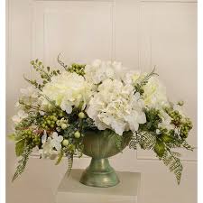 Shop 100s of unique florals options. Elegantly Styled Silk Flower Centerpiece Arranged With White Hydrangeas Accented With Berries Foli Floral Arrangements Flower Arrangements Flower Centerpieces