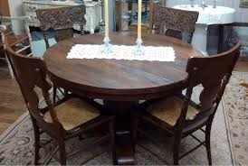 Dining table made of wood in two shades. Vintage Round Oak Pedestal Dining Table With 5 Caned Seat Carved Back Chairs Tamarack Shack Antiques