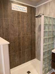 This shower wall comes in a white, glossy finish with the 4 × 8 brick pattern wrapping all around. How To Compare Cultured Stone Laminate Bathroom Shower Wall Panels Innovate Building Solutions