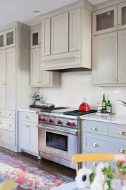The kitchen boasts a single basin stainless steel sink situated beside a stainless steel dishwasher. Gray Kitchen Cabinets With Satin Nickel Cup Pulls Transitional Kitchen
