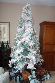 White Flocked Christmas Tree With Turquoise Copper And Brown Wrapped Gifts Ready F White Flocked Christmas Tree Holiday Christmas Tree White Christmas Trees