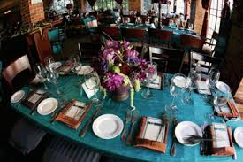 A peacock wedding theme begins with a vibrant wedding color palette and includes lavish elements that together create a mod, chic wedding for the 21st. Peacock Table Decor