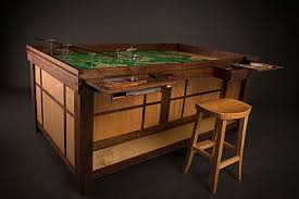 The top of this table can be removed to reveal and inset gaming table, and the side panels can also be moved to reveal extra storage. 10 Coolest Gaming Tables For The Rich Tabletop Gamer