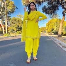 Black And Yellow Suit Design Image May Contain 1 Person Standing And Outdoor Punjabi Outfits Patiala Suit Designs Fashion