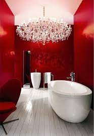 Many homeowners interested in incorporating a red decor theme will start with the linens in their bathroom. Chic Modern Red Bathroom With Chandelier Redbathroom Bathroom Bathroomdesign Bathroomideas In 2020 Red Bathroom Decor Red Interior Design Contrast Interior Design