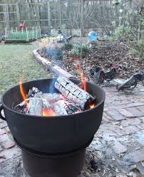 Our Fire Pit Made By Placing A Large Cast Iron Pot With Drainage Holes Drilled In The Bottom On Top Of A Heavy Equi Cast Iron Fire Pit Fire Pit Iron