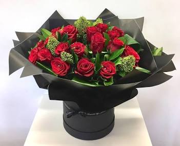 Fresh red roses in a box delivered across Lagos, AI generated
