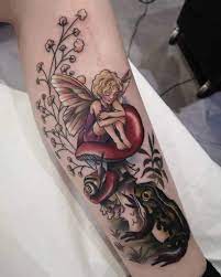 Top 101 Best Fairy Tattoos 2021 Inspiration Guide Beautiful fairy tattoo sitting on mushroom | tattoo viewer.com.