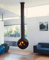 Casual contemporary living room with a hanging fireplace in the center of the sitting area. Pin On Home