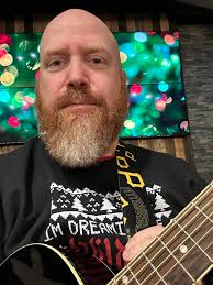 Look at Santa playing the guitar, everyone.