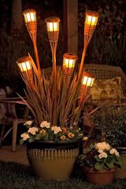 Tiki Torch Planters Brighten Up An Outdoor Space Outdoor Projects Tiki Torches Lawn And Garden
