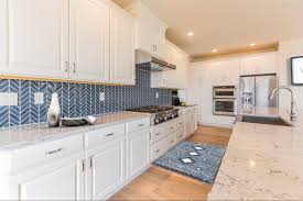 Dramatic grey cabinets complement a neutral backsplash Expert Backsplash Ideas To Complete Your Luxury Kitchen Build Beautiful