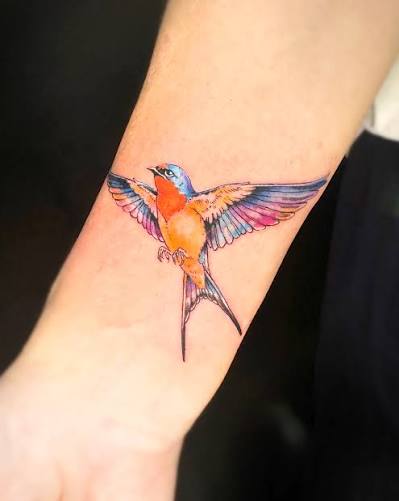 Watercolor swallow by Eak. Soft color transitions with light washes and fine line accents to keep the wings airy and fluid. 🔥 DM to book. #tattoo #bangkoktattoo #thailandtattoo #watercolortattoo #colortattoo #finelinetattoo #birdtattoo #