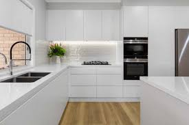 An airy kitchen with dove grey cabinets, a white subway tile backsplash and wooden cuntertops looks cool and bold. Kitchen Ideas Image Gallery Premier Kitchens Australia