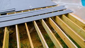 Having attached all the joists, finish up the deck by installing the decking material. Building A Backyard Deck With Composite Deck Boards Installing Stock Photo Picture And Royalty Free Image Image 105653791