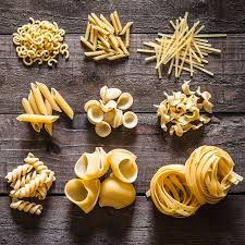 Close up of noodle with chopsticks and coffee to go with laptop on wooden tabletop. 15 Types Of Pasta Shapes Different Types Of Pasta Noodles