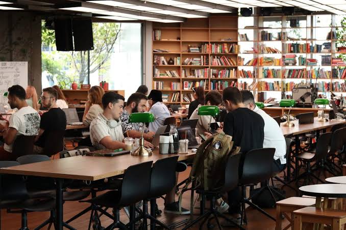People working from a laptop-friendly cafe