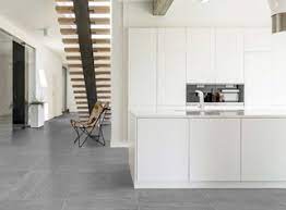 This modern, open concept condo kitchen has blue cabinets, marble island countertops, contemporary dining stools and chairs, and modern ceiling lights. Modern White Kitchen With Grey Porcelain Tiled Floor Modern Kitchen Miami By Simple Steps Houzz Uk