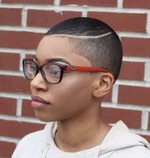The sharp lines of the razored sides and triangular sideburns are tomboyish and pair well with poofy curls on top. Short Natural Haircuts For Black Females That We Recommend