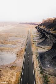 Download Premium Image Of Drone Shot Of A Desert Road 1204748 Desert Road Road Trip Usa Trip