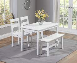 The ultracontemporary dining table is created with a tempered glass table top and a sleek, chrome table base. Mark Harris Chichester White Dining Table With 2 Chairs And Bench Cfs Furniture Uk