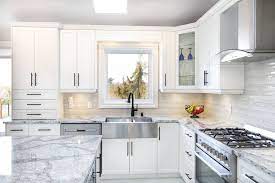 Kitchen renovation by retreat design featuring arredo3 kali cabinetry in matte white & laminam benchtops in statuario bianco venato 12mm. Types Of Kitchen Renovations Time And Budget You Should Plan On For Each Multi Trade Building Services