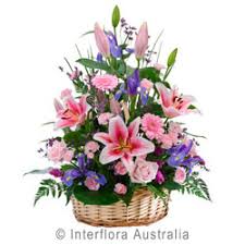 A bouquet of the bride lies on the grass. Beautiful Basket Of Mixed Flowers
