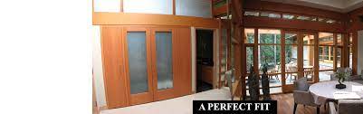 Contemporary garage doors constructed from reclaimed redwood sourced from various dismantled structures throughout the united states, including old barns and bridges, as well as wine, olive, water and other tanks. Custom Wood Doors Windows Victoria Bc