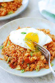 Kimchi Fried Rice Kimchi Bokkeumbap Served On A Plate With A Runny Sunny Side Up Egg On Top In 2020 Kimchi Fried Rice Kimchi Recipe Food
