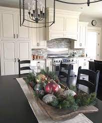 Pine boughs are tucked into this gorgeous chandelier, while ribbon adds a touch of elegance. 33 Inspiring Christmas Decor Ideas To Elevate Your Dining Table