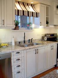This classic red kitchen features bright white cabinets and a sleek black countertops. Cafe Kitchen Decorating Pictures Ideas Tips From Hgtv Hgtv