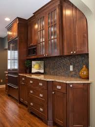 Hgtv Presents A Warm Transitional Kitchen With Dark Wood Cabinets A Mosaic Tile Backsplash And Stainless Steel Kitchen Design Craftsman Kitchen Home Kitchens