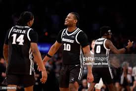 Rich Barron reacts with Corey Floyd Jr. #14 of the Providence Friars...  News Photo