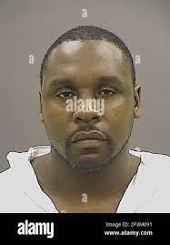 In this undated photo provided by the Baltimore Police Department, Dennis  Padgett appears in a booking photo, in Baltimore. Baltimore Police said  Padgett shot and killed two of his neighbors after a