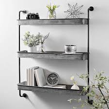 In the center, there are three brown wood planks that have light whitewash detailing. Galvanized Metal 3 Tier Wall Shelf Kirklands
