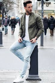 Magic Fox With A Great Streetwear Combo Featuring An Olive Bomber Jacket White T Shirt Light Wash Denim Mens Outfits White Sneakers Outfit Mens Casual Outfits
