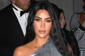 Kim Kardashian Wears Gold Bustier, Miniskirt & Heels For Birthday Trip