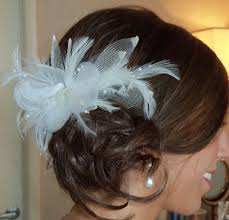 Side Style Loose Bun With Feather Fascinator Hair Updos For Weddings Guest Wedding Guest Hairstyles Wedding Hairstyles Updo