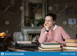 Different exam resources for different lifestyles. Diligent Student Brunette Girl A Student In A Pink Sweater Thoughtfully With A Slight Smile Looks Into The Distance Stock Photo 160455323 Megapixl
