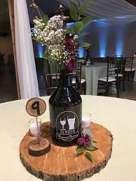 Growlers Used For A Table Centerpiece Brewery Wedding Rustic Outdoor Theme In Fenton Michig Brewery Wedding Beer Themed Wedding Wedding Floral Centerpieces