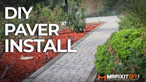 Staggered paver stones in grass lead to a modern fire pit situated poolside. Diy Paver Walkway Installation Youtube