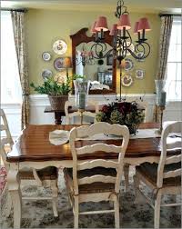 A mix of dining chairs surround the table, from a french settee to a wingback chair and an armless louis chair.a barn wood panel and an empty french frame has been used as wall decor. French Country Dining Table You Ll Love In 2021 Visualhunt