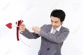 Male Asian In Suit Posing In A Studio With Cupid Arrows Stock Photo,  Picture And Royalty Free Image. Image 85402737.