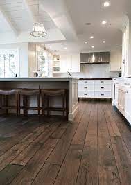 You'll need to precisely measure the floorboards before cutting them to size to ensure they fit tightly underneath the cabinets. Signature Hardwoods Glencoe Ii Residence Victorian Collection Vintage French Oak In Bronze House Flooring Rustic Wood Floors Farmhouse Flooring