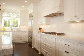 The door front has a raised panel with raised stile and rail edges. White Raised Panel Inset Hartville Cabinet