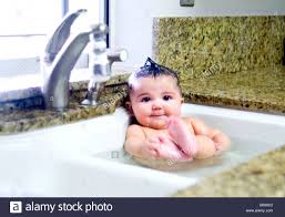 Follow these steps to safely bathe your baby: Bathing Baby In Kitchen Sink Online